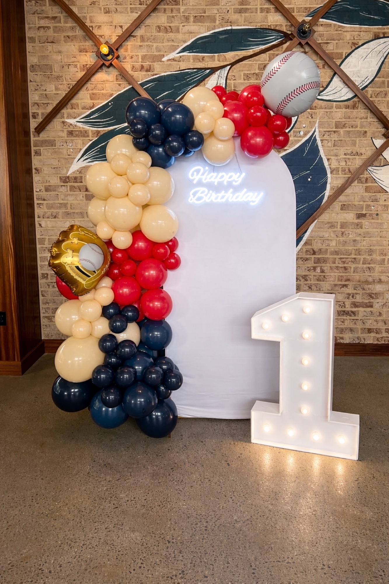 Baseball themed first birthday balloon installation.