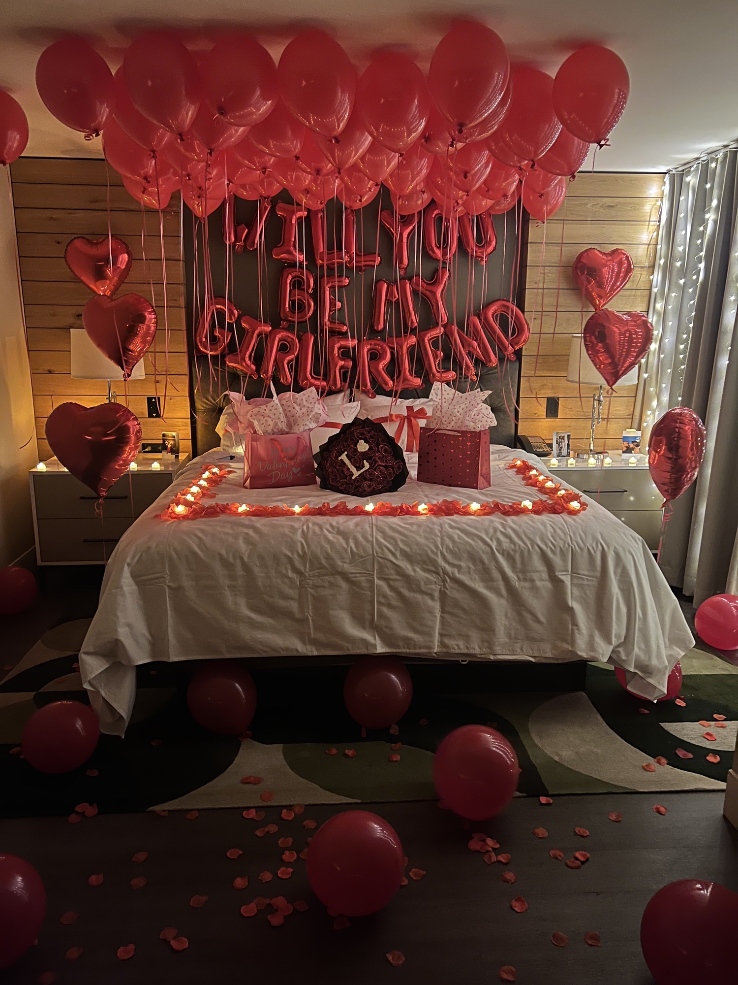 Will you be my girlfriend proposal room, floor view with petals.